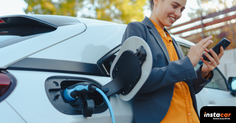 a woman charging her plug-in hybrid car